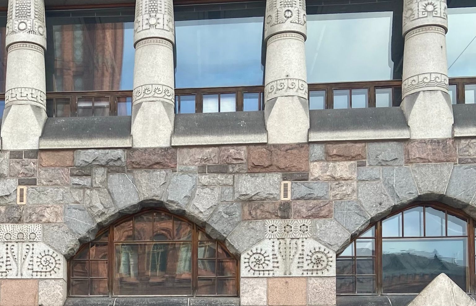 Decorative stone columns and carved details on a National Romantic building in Helsinki