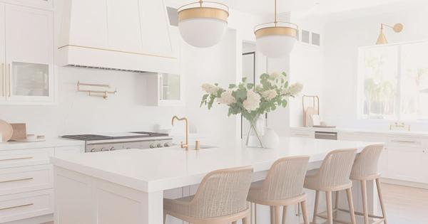 Bright white kitchen with gold fixtures and light oak accents, showcasing Silicon Valley home staging and preparation tips from Realtor April Tavares of the Iniguez & Tavares Team.