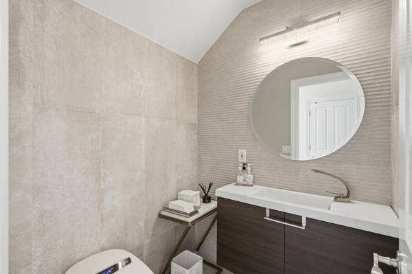 Renovated first-floor powder room with elegant modern finishes in Cambrian home