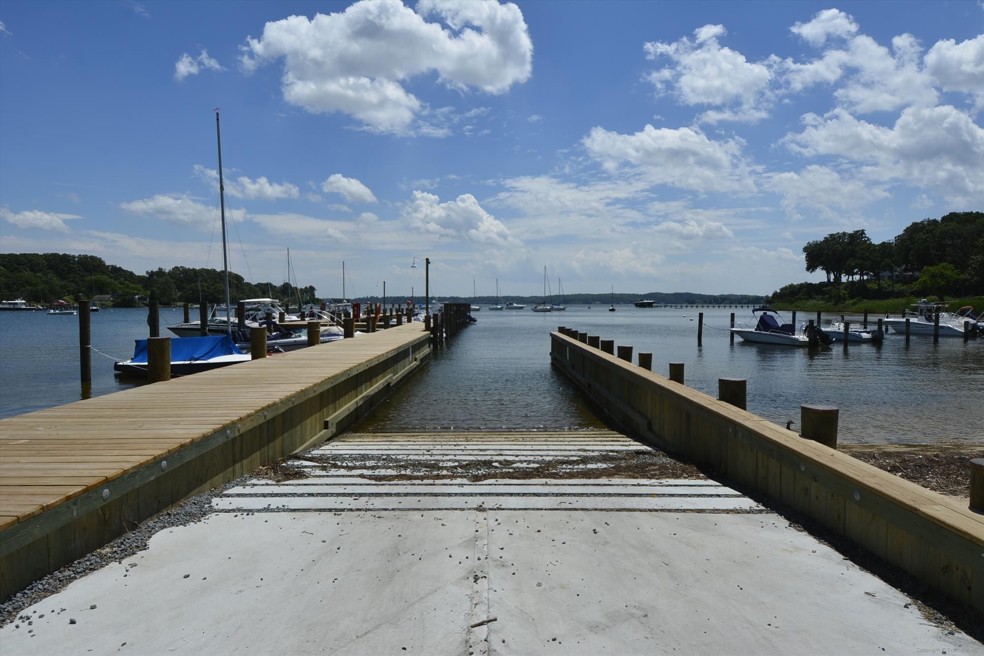Concrete boat ramp between two wooden piers leading into Sullivan's Cove