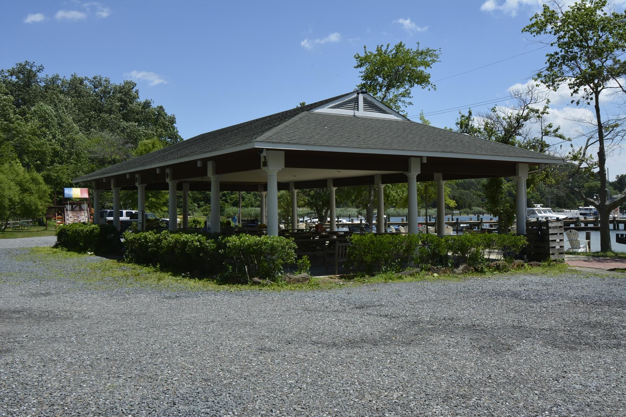 Open-sided pavilion with picnic tables beside the water at Hatton Memorial Beach