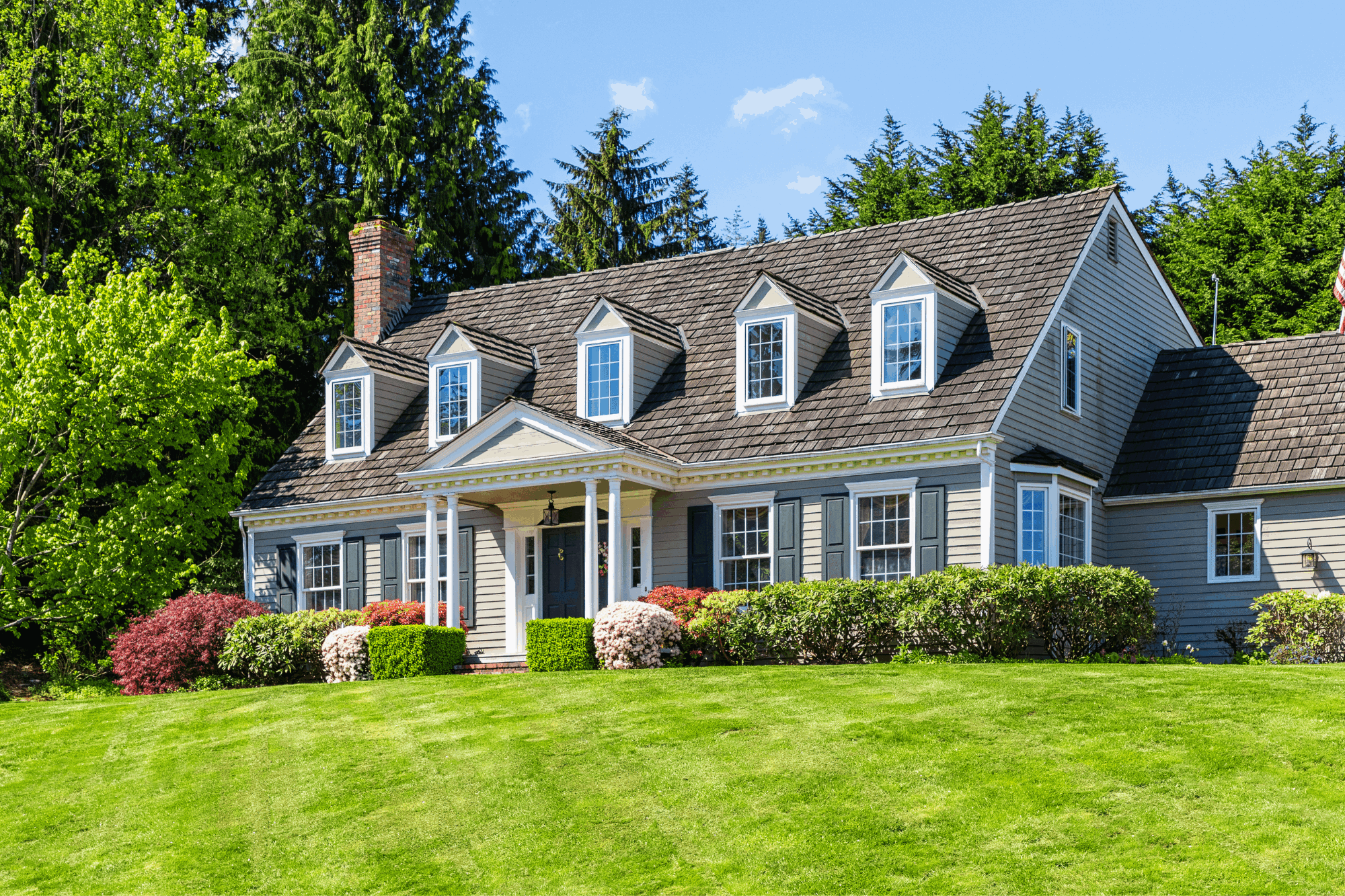 Cape Cod style home with dormer windows and manicured lawn in Annapolis, MD