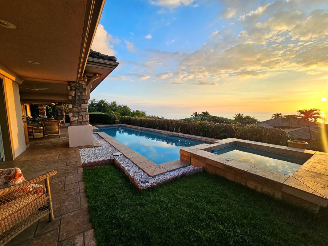 Sunset view from 78-7043 Mololani St showing the pool, spa, and wide ocean horizon in Bayview Estates, Kailua-Kona