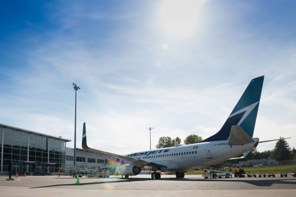 WestJet jet at Comox Valley Airport terminal in Comox, BC