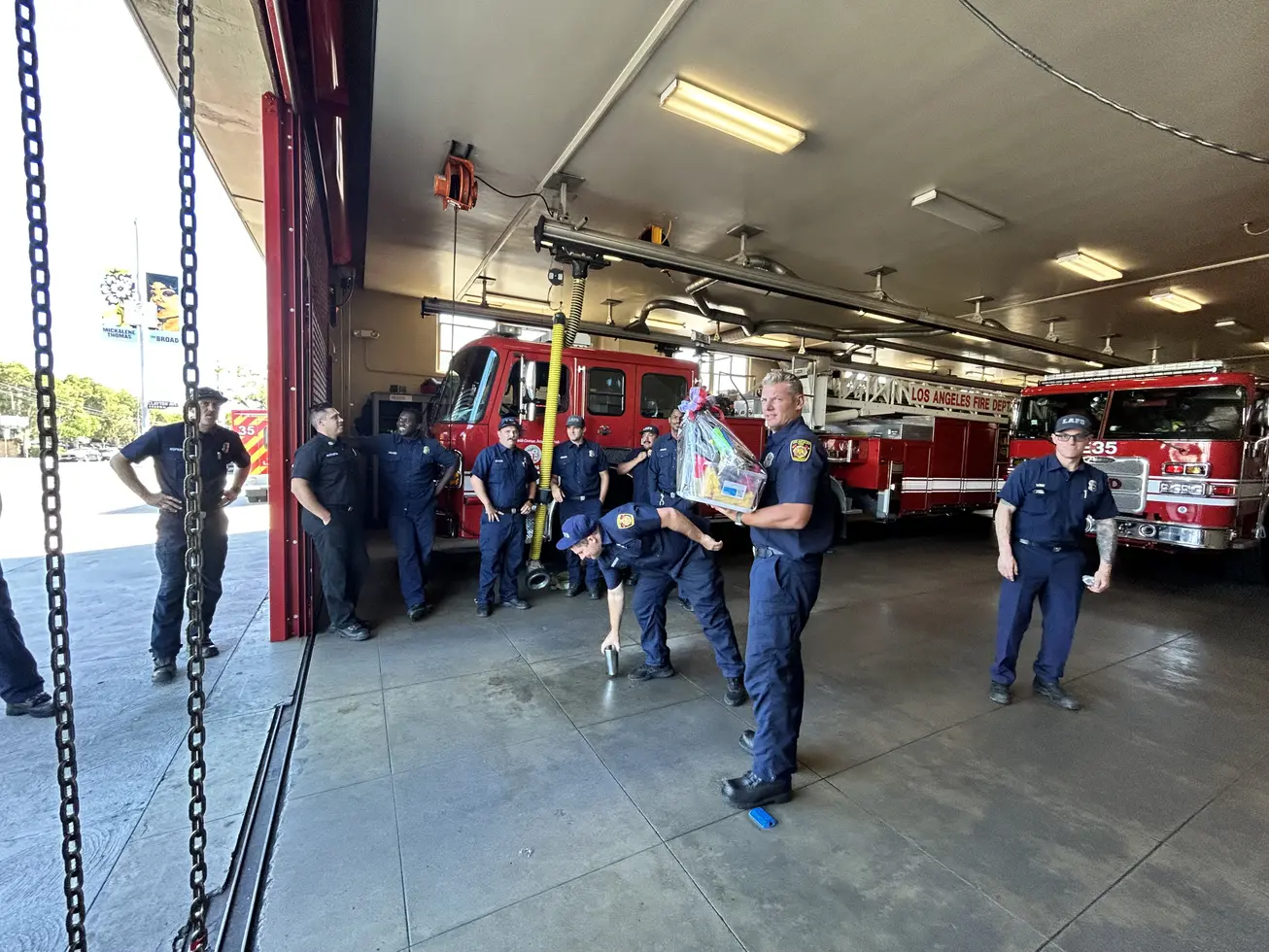 Station 35 firefighters unloading a delivery in the engine bay
