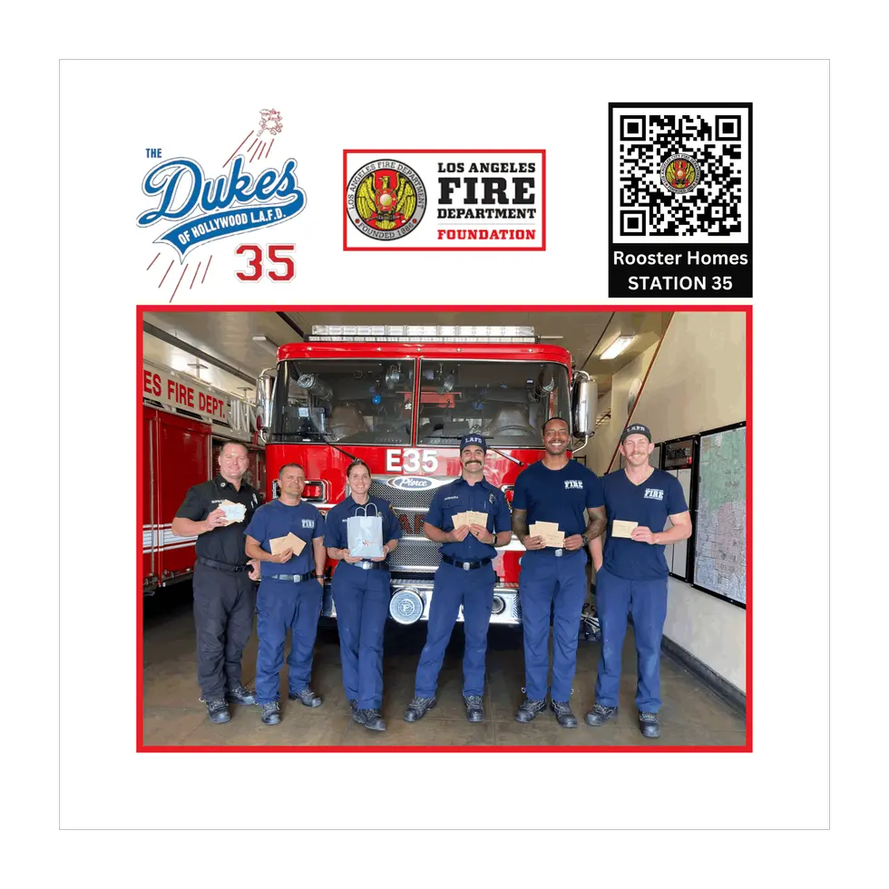 The Station 35 crew in front of Engine 35 holding Rooster Homes gift envelopes