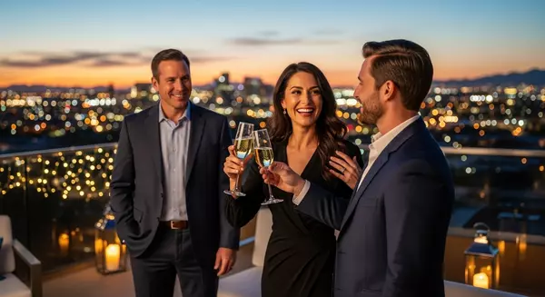 Luxury home sellers in Scottsdale celebrating success with a sunset city view.