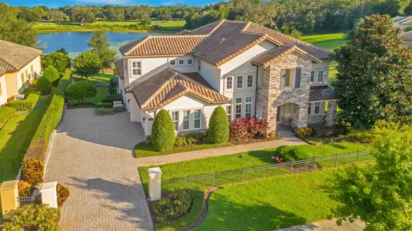 An aerial view of this expansive 0.93-acre estate, offering lakefront living, a beautiful and private  backyard on serene Lake Hugh.