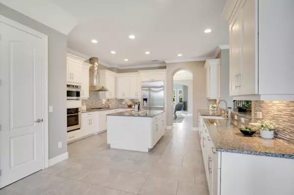 Elegance meets functionality in this stunning kitchen, boasting granite counters and top-of-the-line appliances.