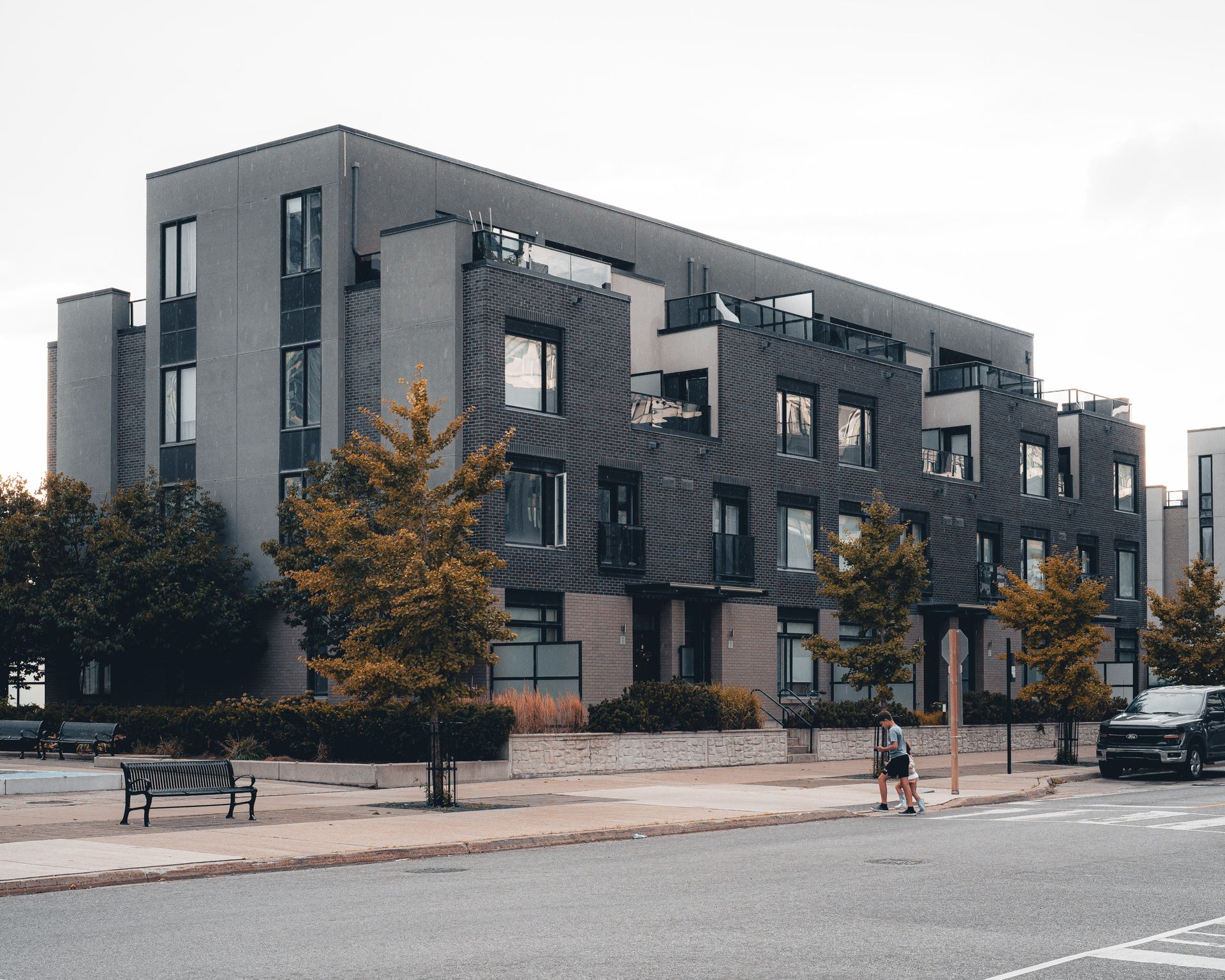 Contemporary mid-rise condo with glass terraces on a suburban Mississauga or Oakville street