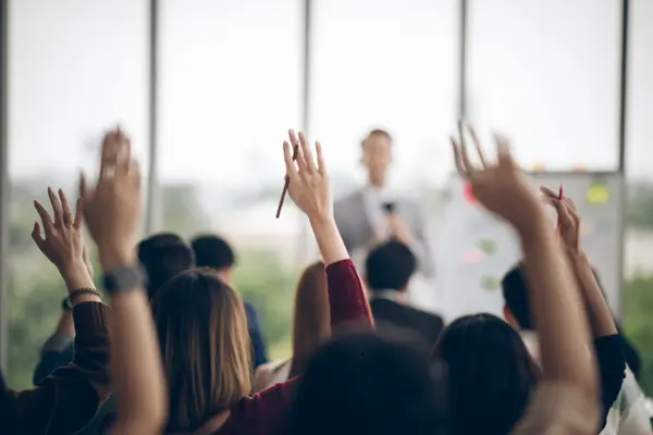 participants-raising-hand-at-seminar