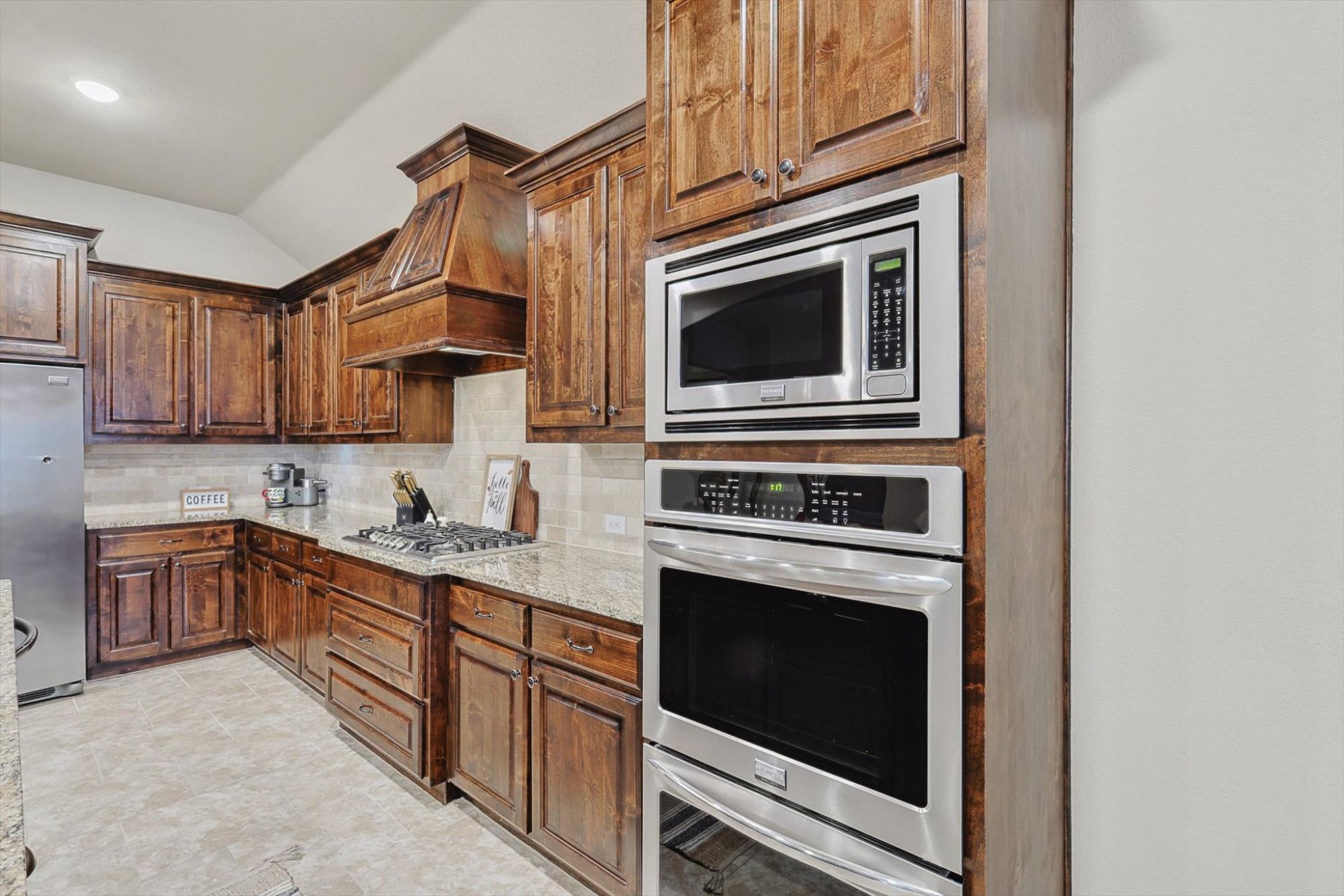 Open-concept kitchen with granite counters double ovens and stainless steel appliancesn Park home for sale