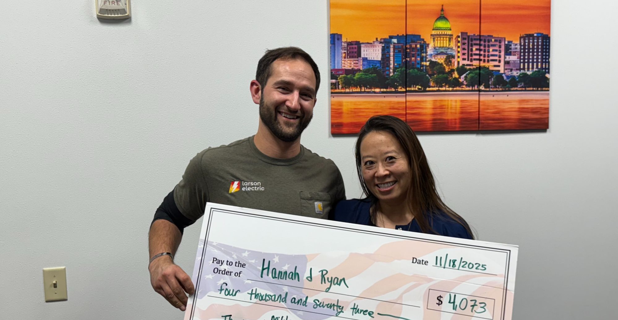 John Reuter of Integrity Homes presenting a Reward Our Heroes check to a local community hero who purchased a home in Madison, Wisconsin.