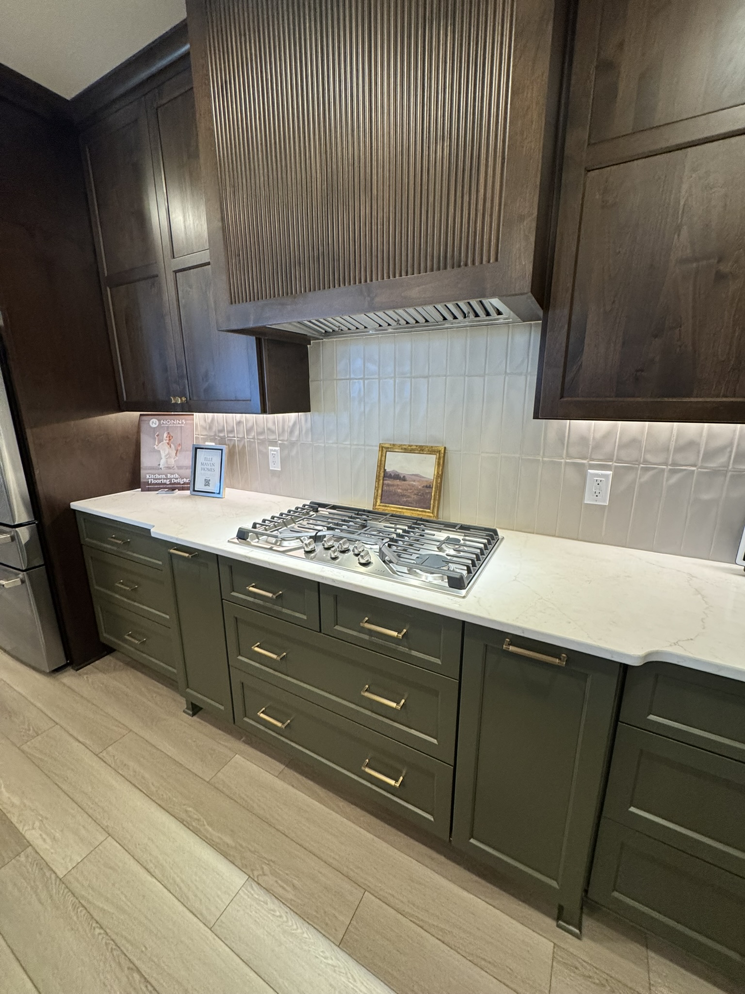 Kitchen in a recent Madison-area Parade of Homes with olive green cabinets and quartz counters