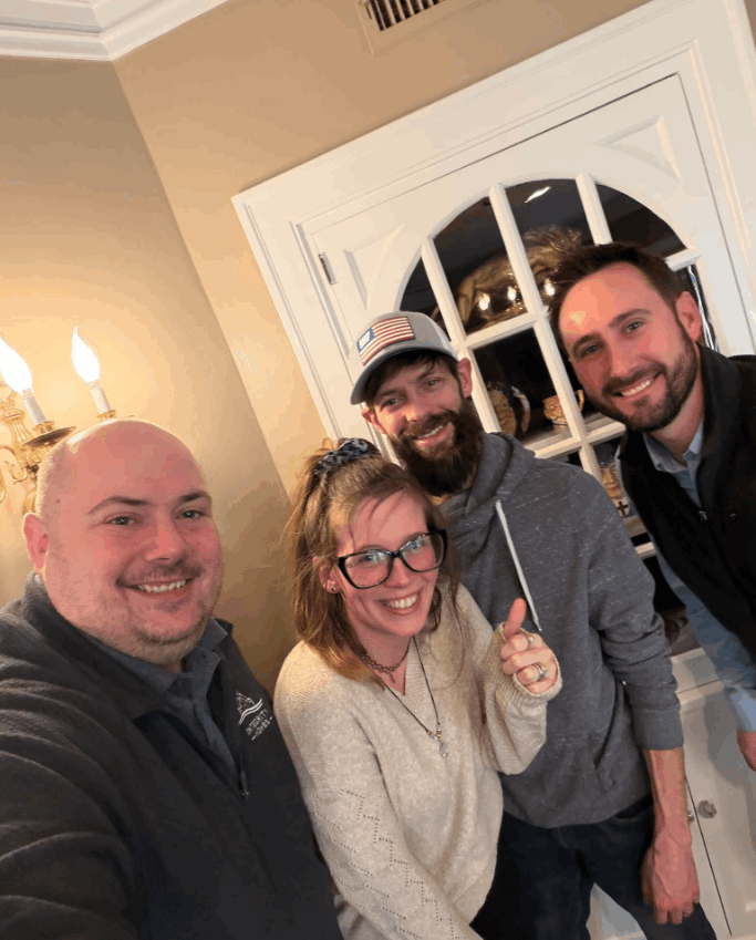 John Reuter of Integrity Homes with buyers holding the keys to their new home on closing day