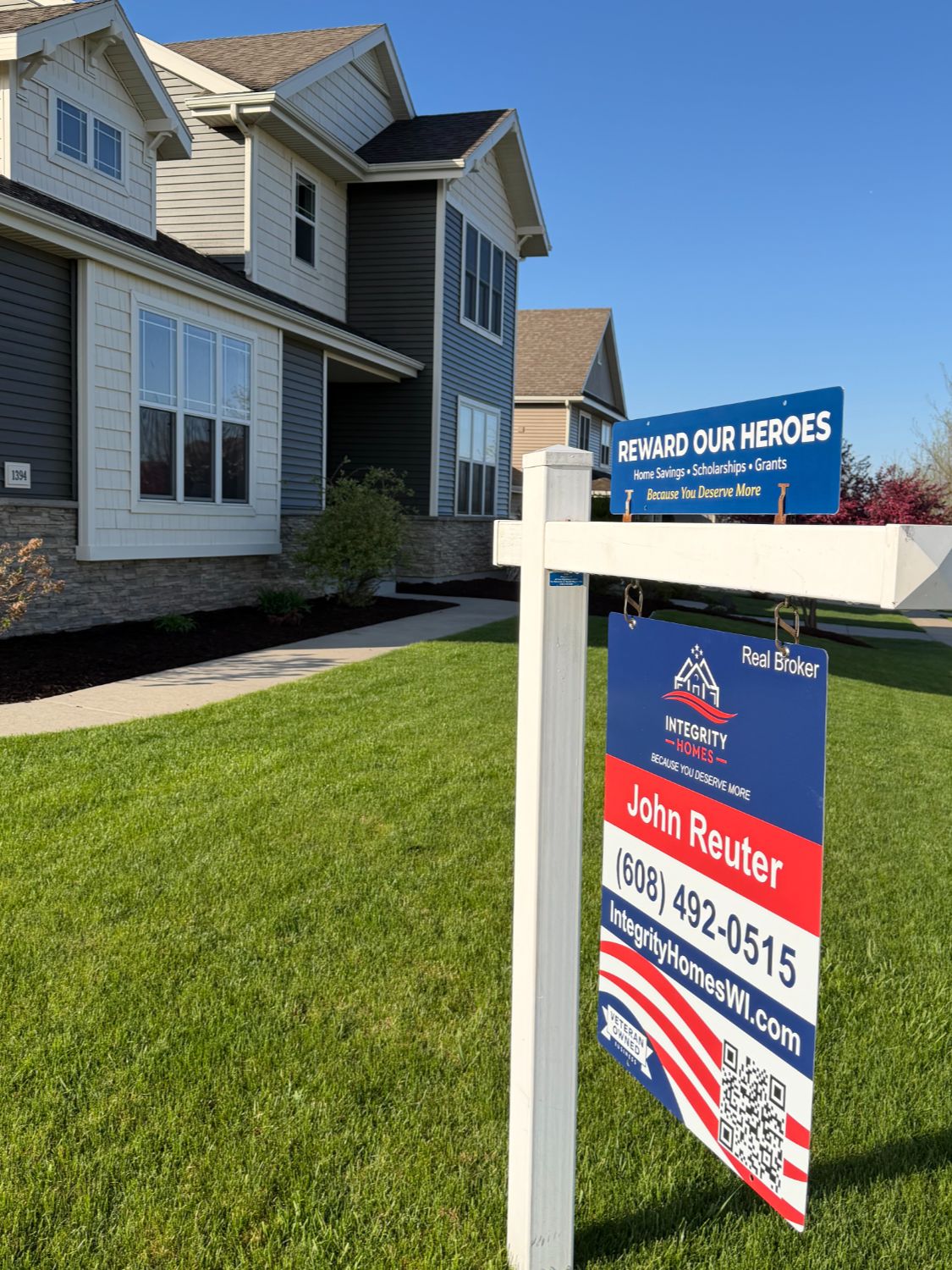 Integrity Homes 'For Sale' sign featuring John Reuter, in front of a Cathedral Point listing on Winchester Pass, Verona, Wisconsin