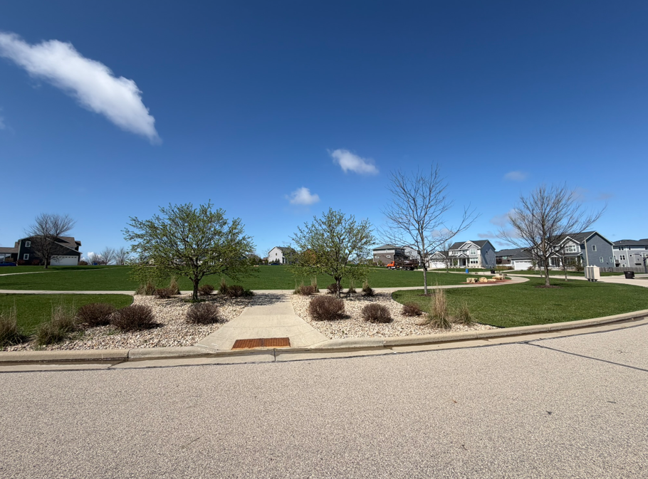 Aerial view of Cathedral Point's Memory Garden, a landscaped oval green space surrounded by homes, Verona, Wisconsin