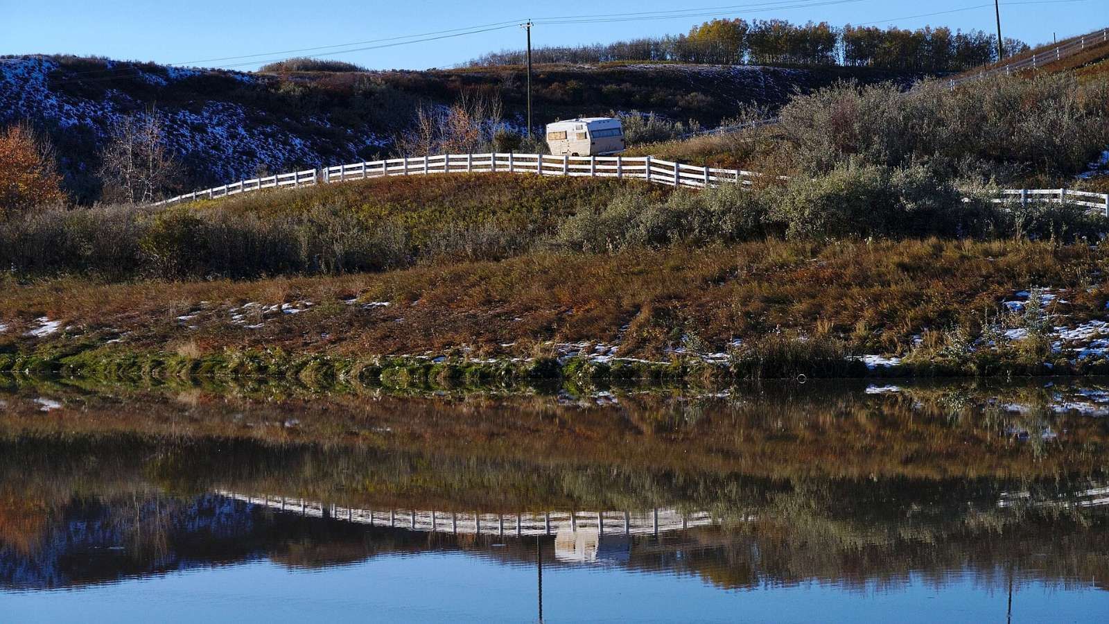 A pond with autumn reflections in Fish Creek Provincial Park, which borders Canyon Meadows, Calgary.