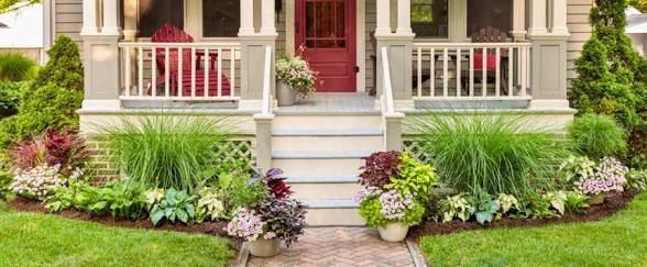 Tall decorative planters with lush green plants on a beautiful patio