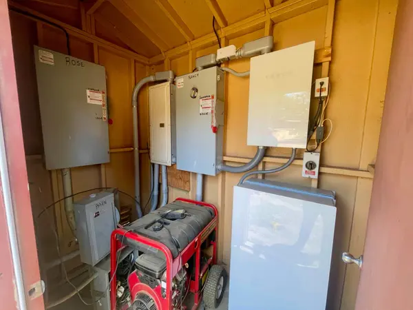 On-site power distribution shed with electrical panels and battery backup system