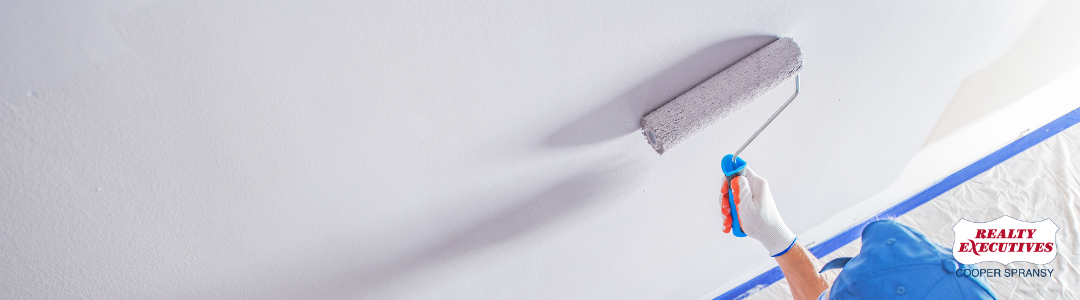 Man Painting a wall white