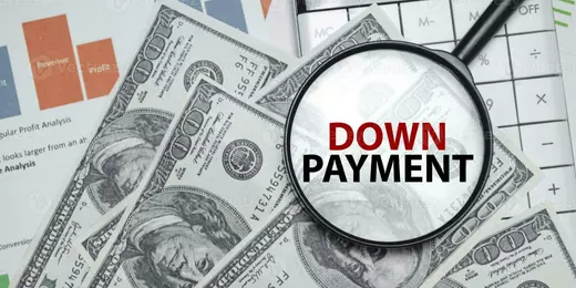 down-payment-word-on-magnifying-glass-with-dollars-and-charts-photo