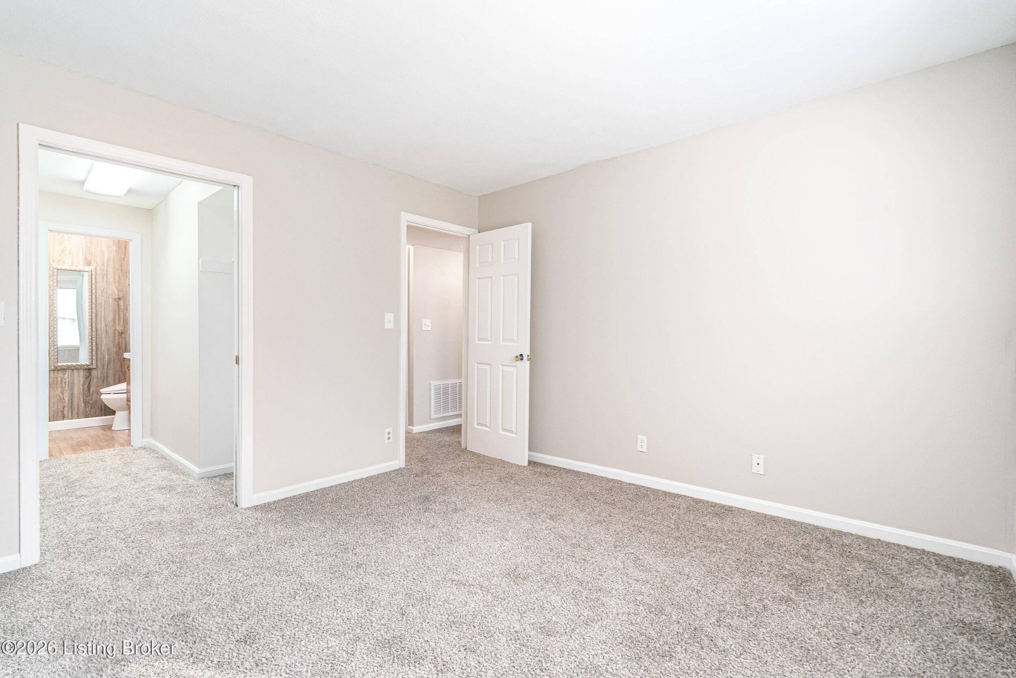 Primary bedroom with ensuite bath Louisville condo