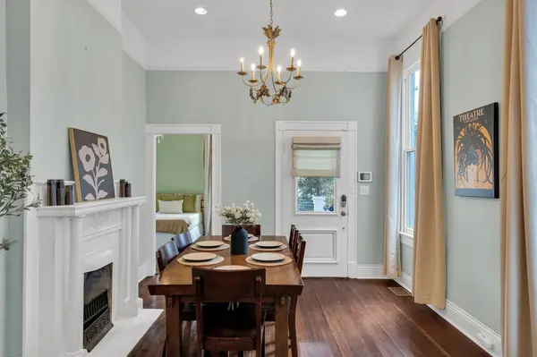 Staged dining room with fireplace and gold chandelier