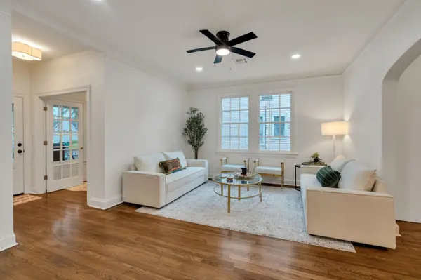 Staged living room with cream sofas and gold accents