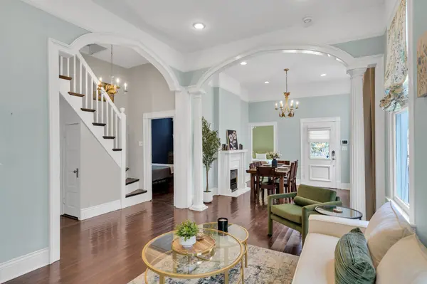 Staged living room with arches and columns in a historic New Orleans home