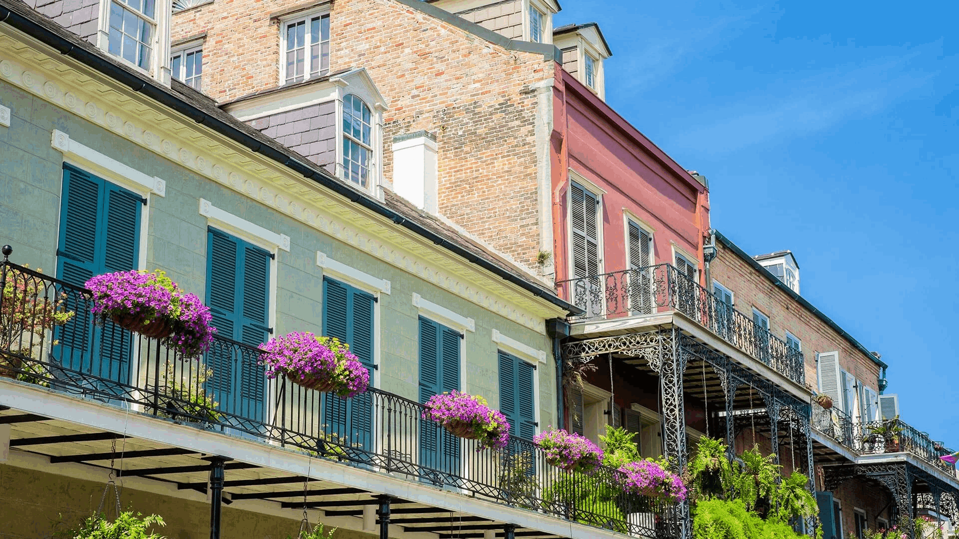 Green shutters and flower boxes on a French Quarter balcony