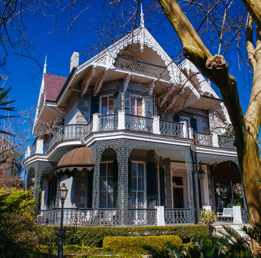 Iron lace gallery and azaleas in the Garden District