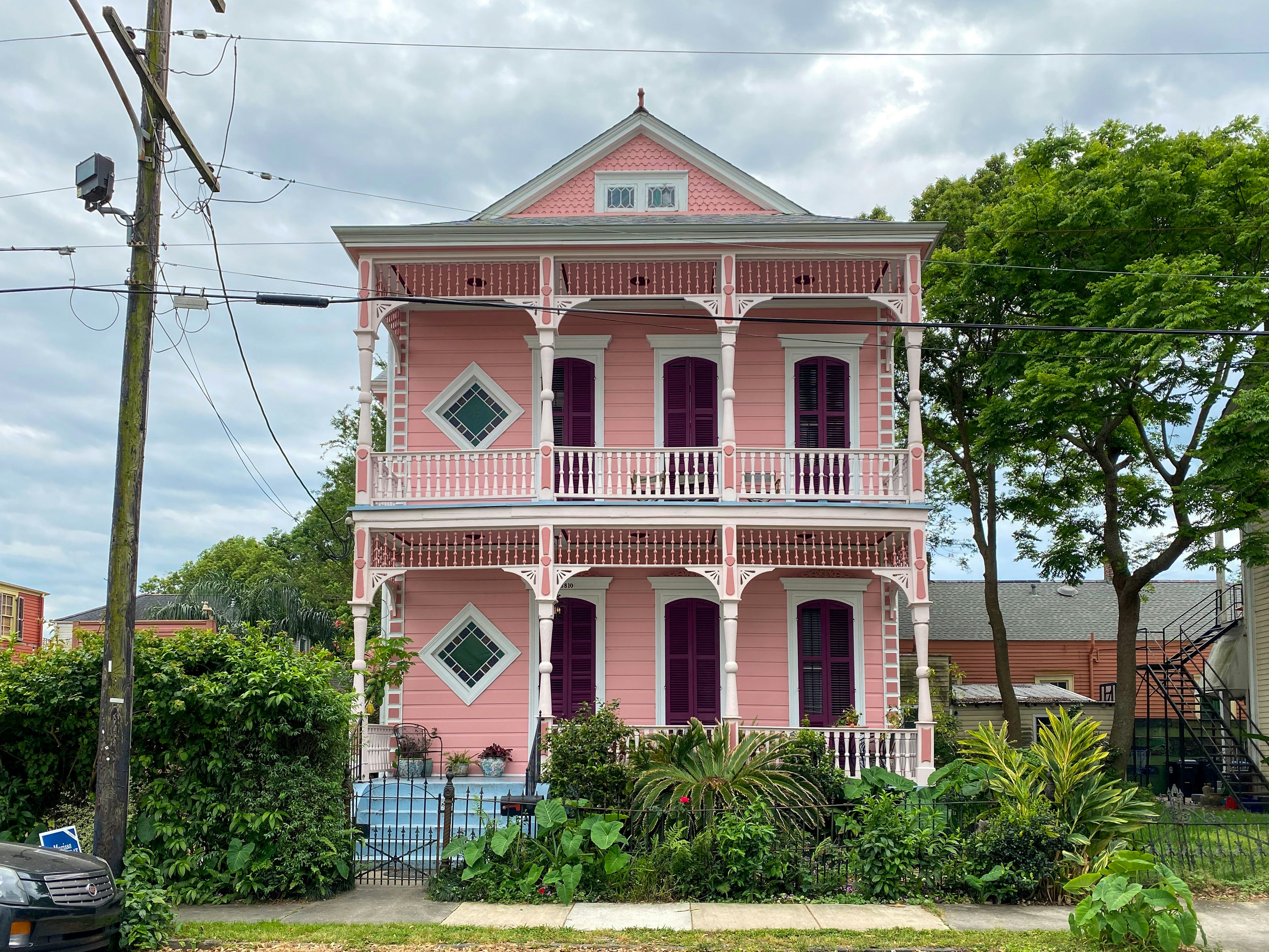  A pink house with white trim and blue steps in Louisiana