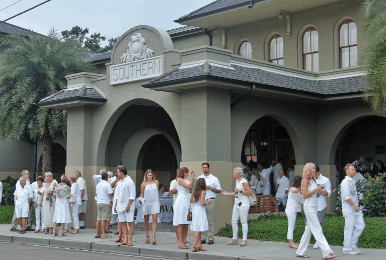 Guests dressed in white gather outside Southern Hotel during the Covington White Linen for Public Art