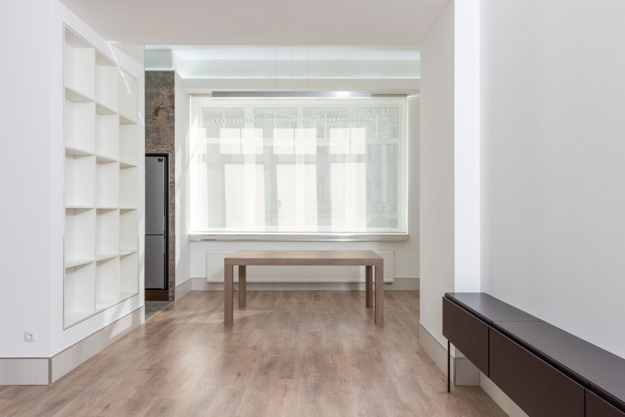  Bright minimalist living room interior with wooden flooring and simple furniture
