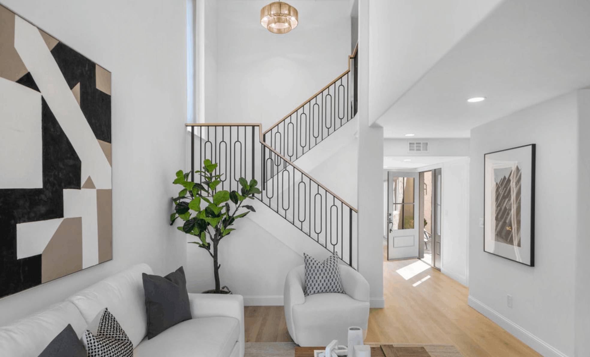 Open stair with an iron railing under a pendant light