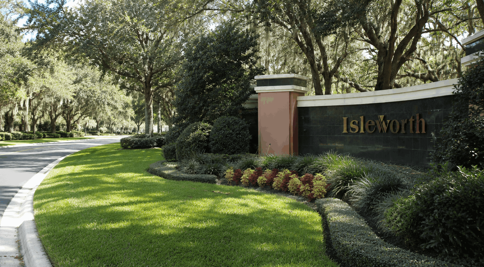 Gated community entrance with manned security guardhouse in Isleworth, Florida