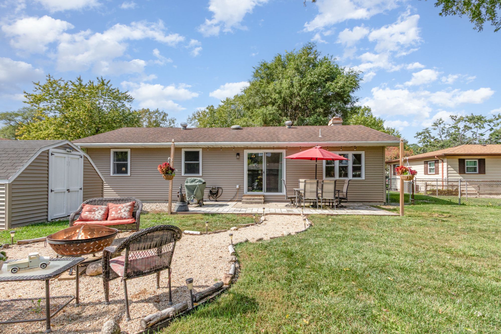 Fenced backyard with patio and firepit at 3339 Ashland Ave in Portage Indiana