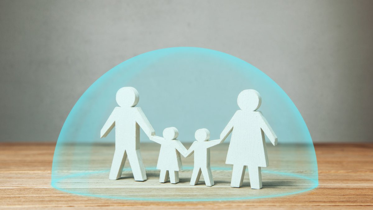 an image of a paper cutout family with a virtual bubble around them symbolizing protection