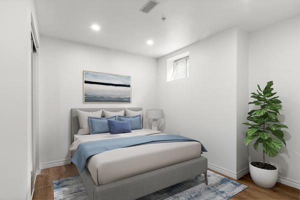 Primary bedroom with mirrored sliding closet and above-grade windows at 392 Clarkson Gate Milton