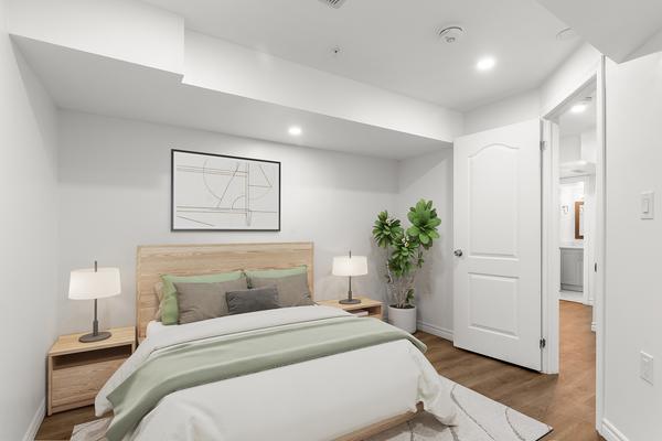 Second bedroom with large window at brand-new legal basement suite 392 Clarkson Gate