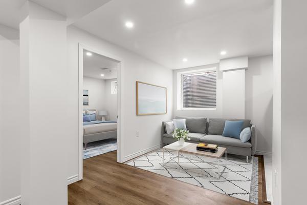 Open-concept living area with vinyl plank flooring and pot lights at 392 Clarkson Gate Milton