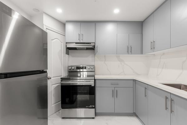 Modern kitchen with LG appliances, quartz countertops and backsplash at 392 Clarkson Gate