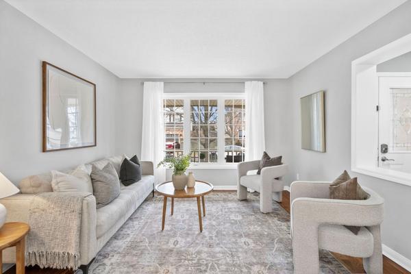 Bright formal living room with large window overlooking tree-lined street at 1537 Morse Place Beaty Milton