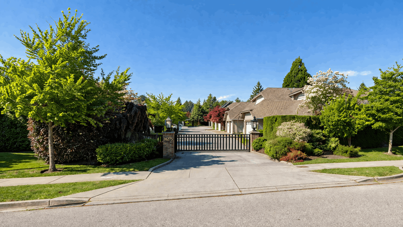 Exterior entryway view of a Sunrise Pointe townhouse in South Surrey featuring a gated community, landscaped entry