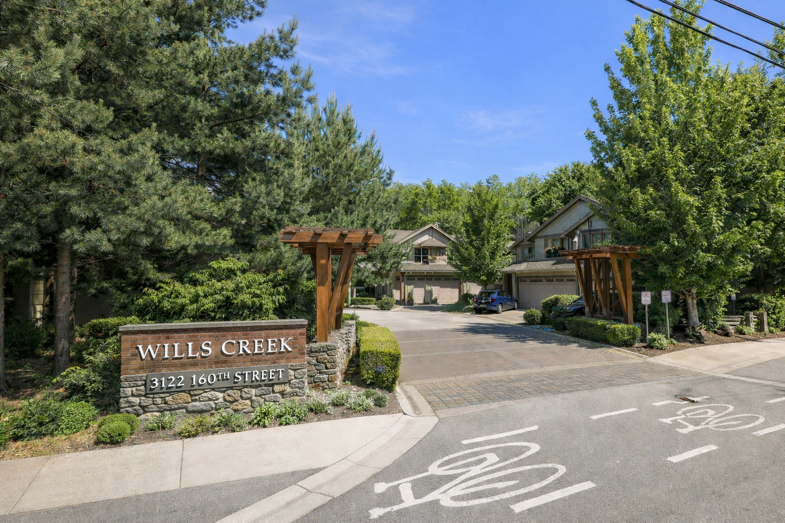 Entrance to Wills Creek townhomes at 3122 160th Street South Surrey featuring landscaped grounds and residential buildings in Grandview neighbourhood