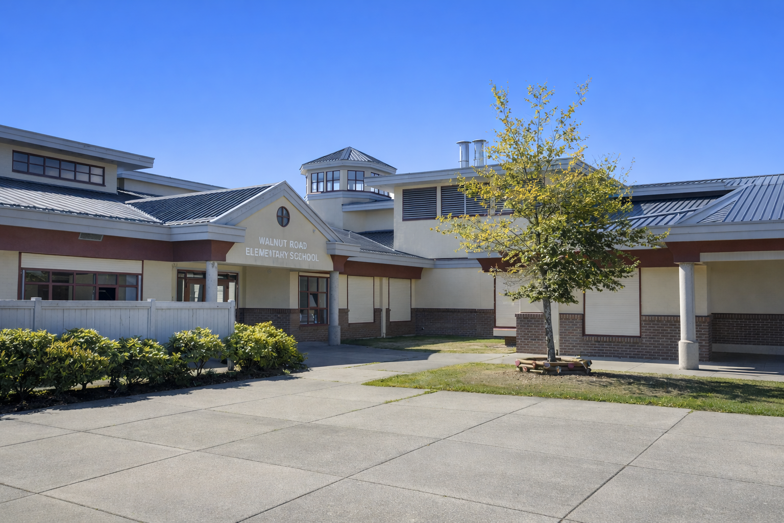Walnut Road Elementary School in Surrey BC exterior view showing front entrance, school building, landscaped grounds, and clear blue sky