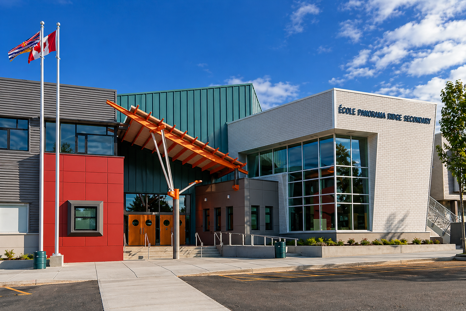 Front exterior view of Panorama Ridge Secondary School in Surrey BC, featuring modern architecture, glass entryway, flags in the neighbourhood of Newton.