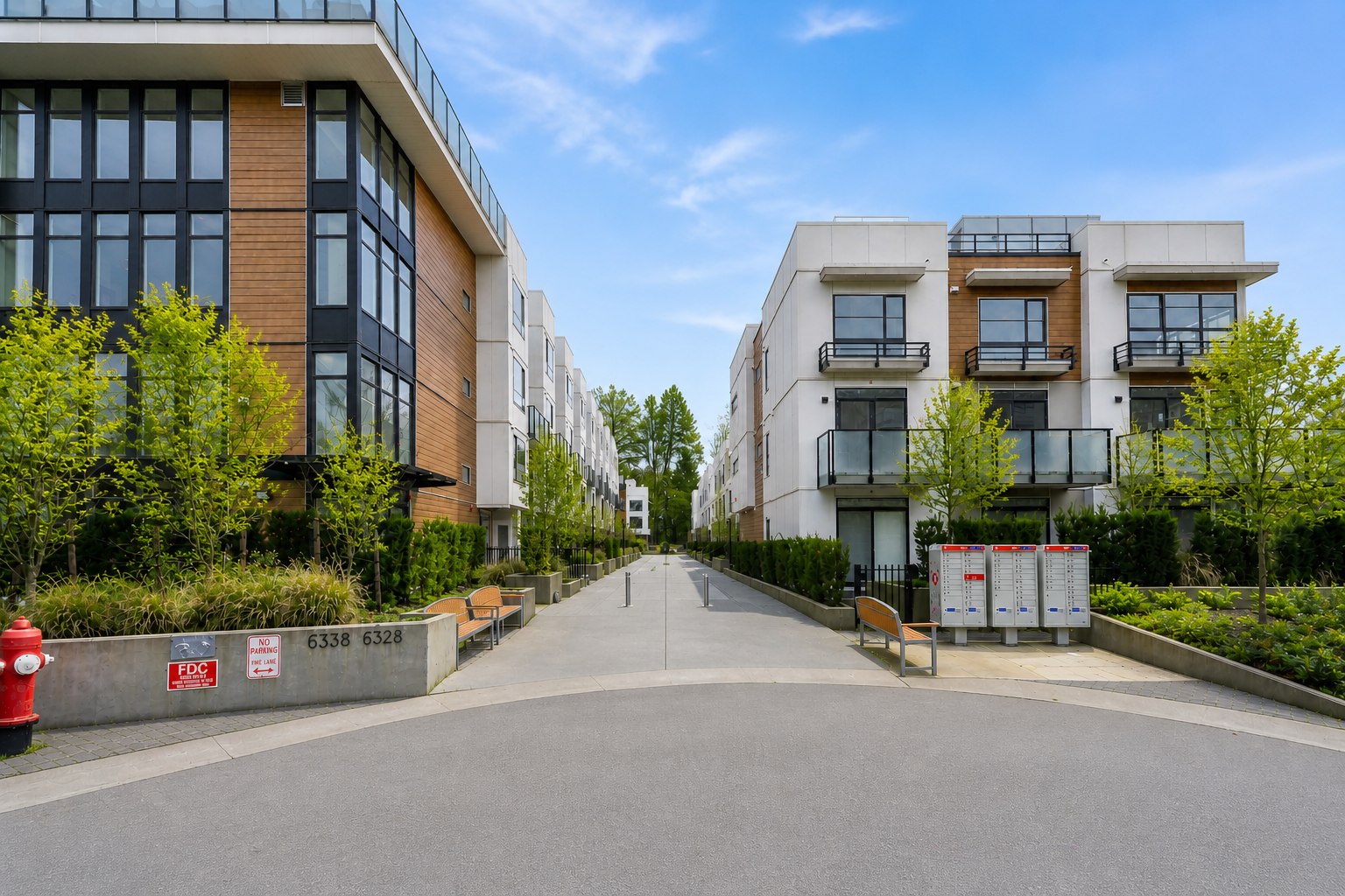 Entrance view of Creekside Terrace townhomes at 6328 King George Blvd Surrey BC showing modern buildings, landscaped walkway, and courtyard access