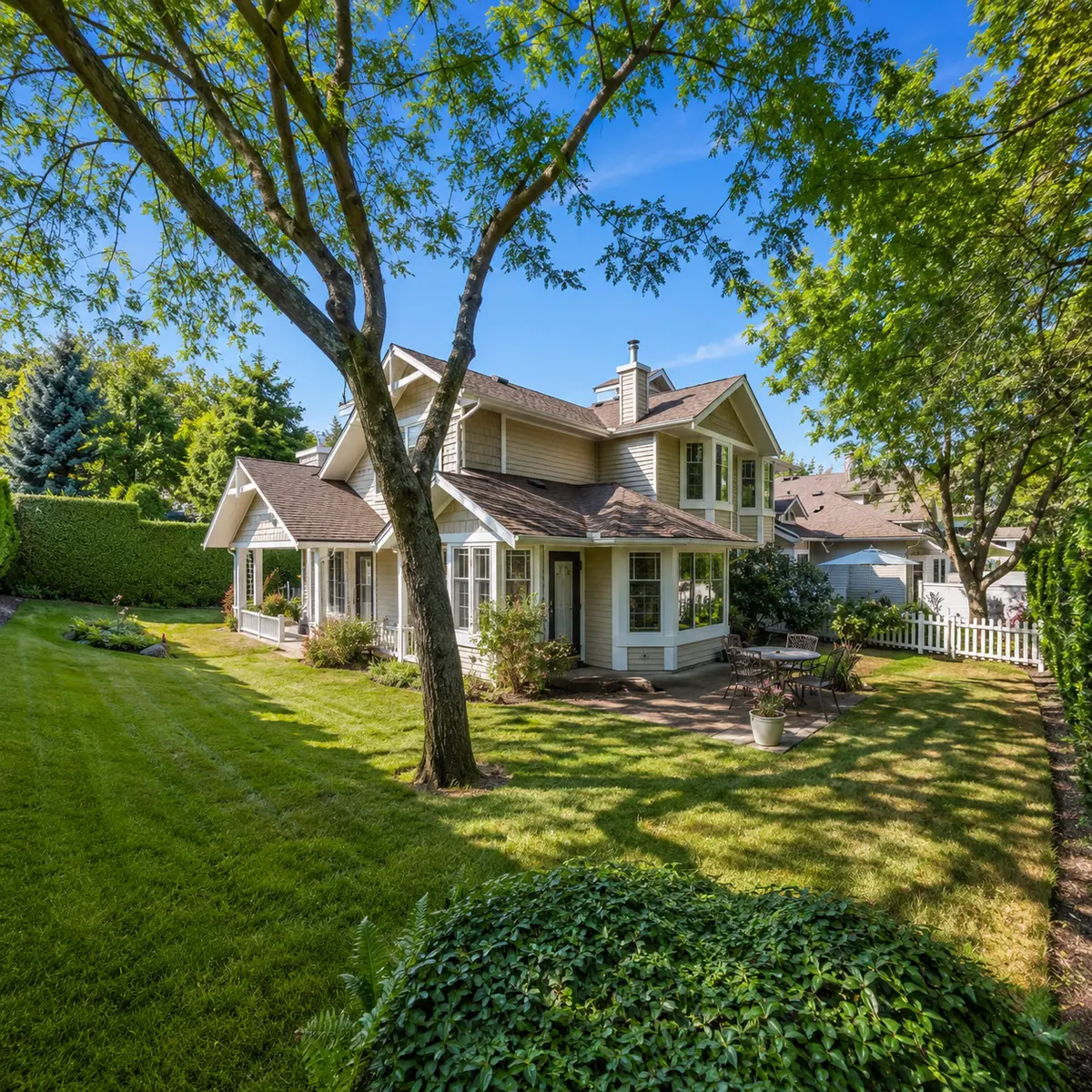 Private backyard and patio area at a Turnberry Townhome in Cloverdale Surrey BC featuring mature landscaping, green space, and outdoor living areas within the 55+ gated community.